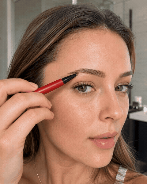 Animated close-up of an unbranded four-tip eyebrow pen application
